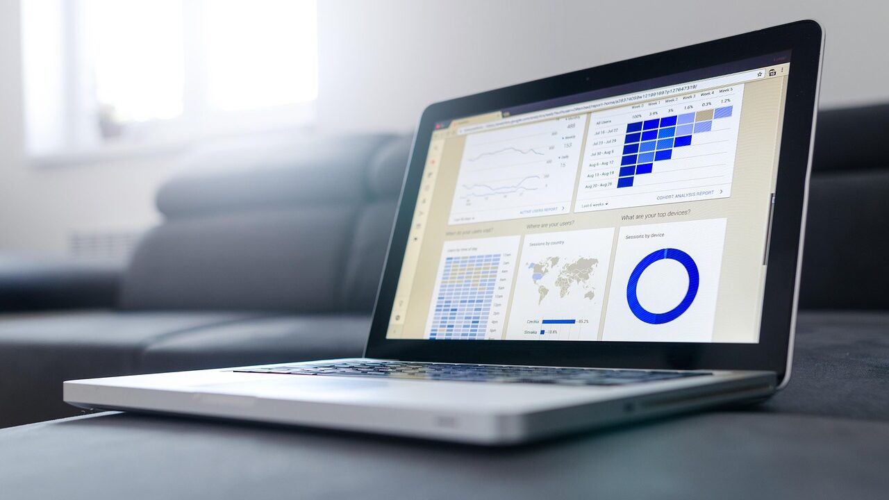 A notebook and business statistics laid out on a desk, representing the analysis behind a company's double materiality assessment